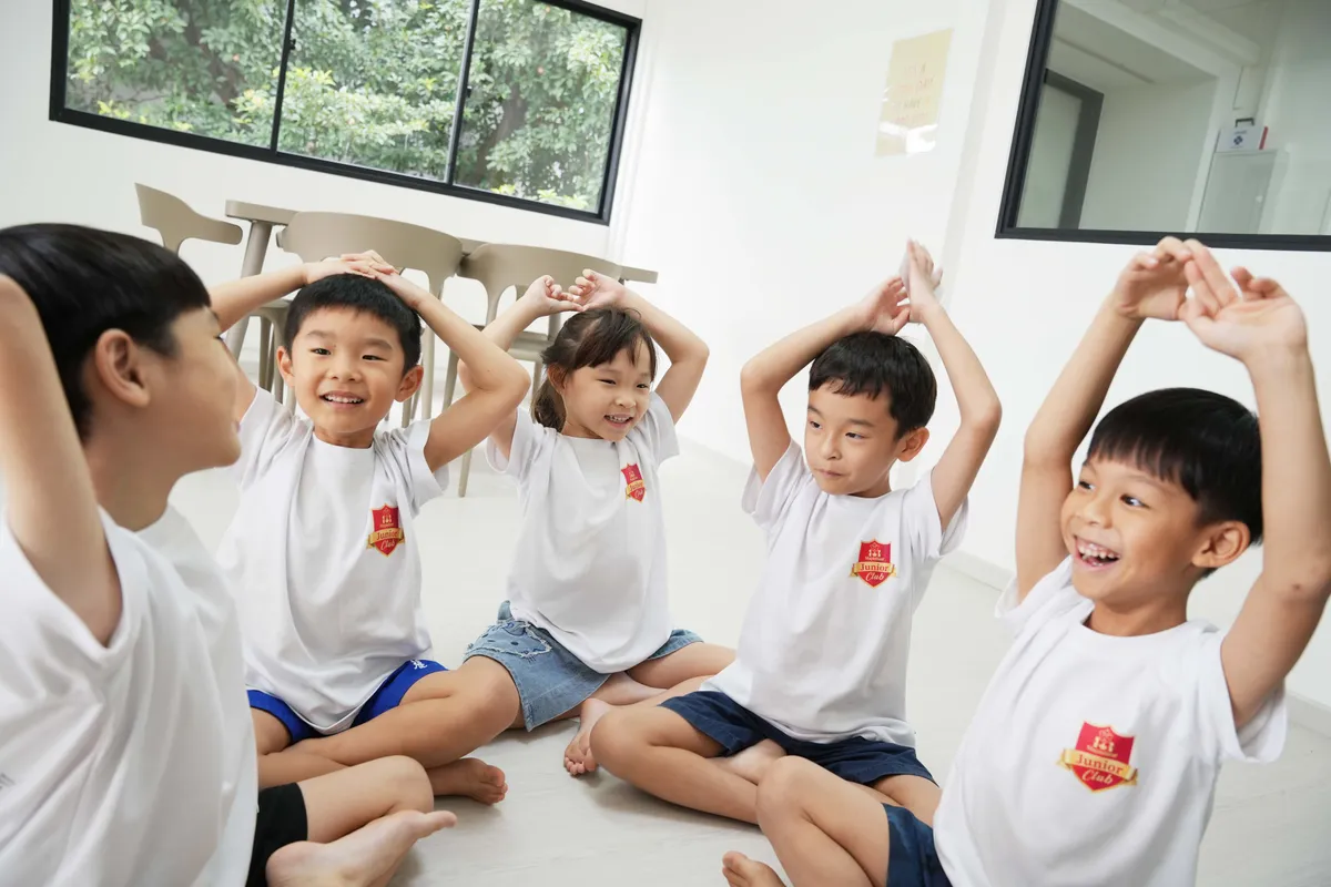 Children at Maple Bear Junior Club Eunos smiling together during a group activity
